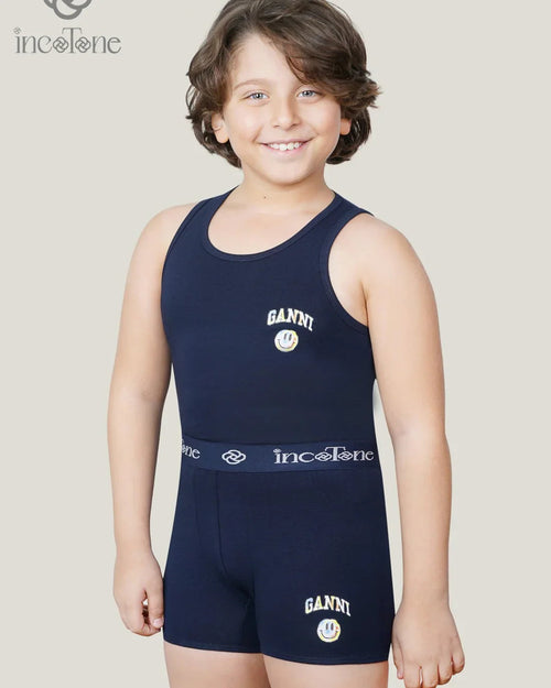 Child wearing a navy blue athletic outfit with 'Ganni' and 'incotone' branding on a plain background.