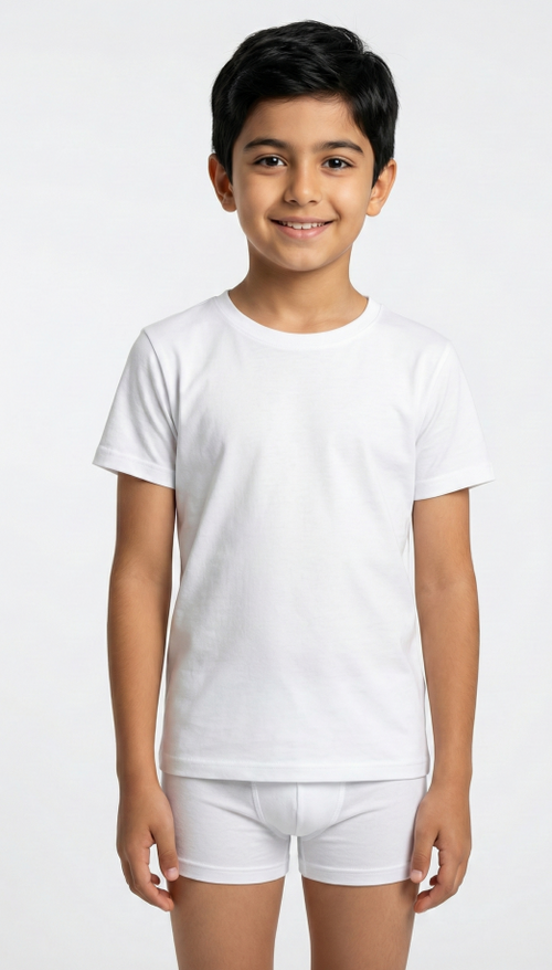 Child wearing a plain white t-shirt and shorts on a light gray background