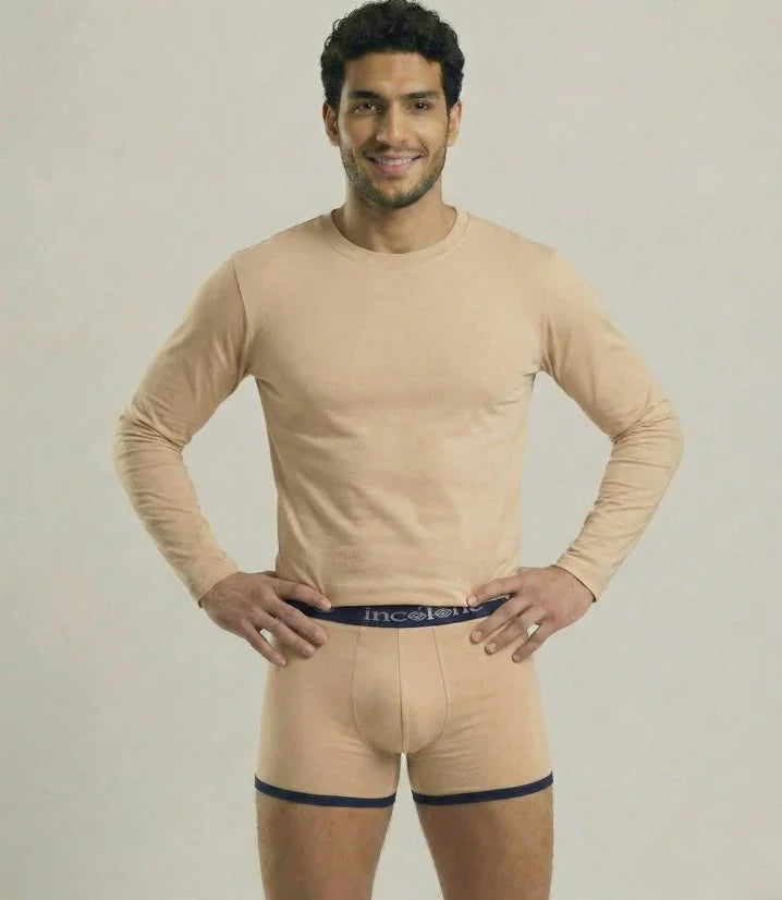 Man wearing beige long-sleeve shirt and underwear set on a plain background