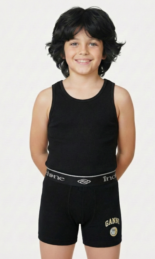 Child wearing a black tank top and black shorts with visible branding on a white background